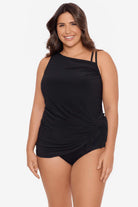 Woman wearing a black swim dress with different straps