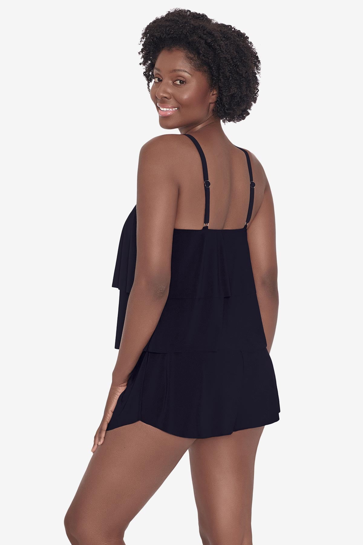 Woman faced left wearing a black tankini top with ruffles