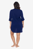 Woman turned away wearing a navy-blue shirt dress swim cover up