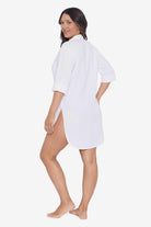 Woman faced left wearing a white shirt dress swim cover up