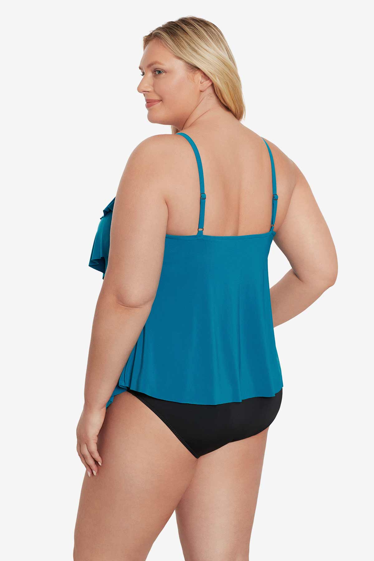 Woman turned left wearing a blue tankini top with ruffles