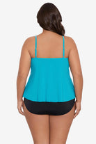 Woman turned away wearing a light blue tankini top with ruffles