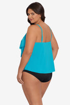 Woman turned left wearing a light blue tankini top with ruffles