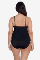 Woman faced away wearing a black tankini top with ruffles
