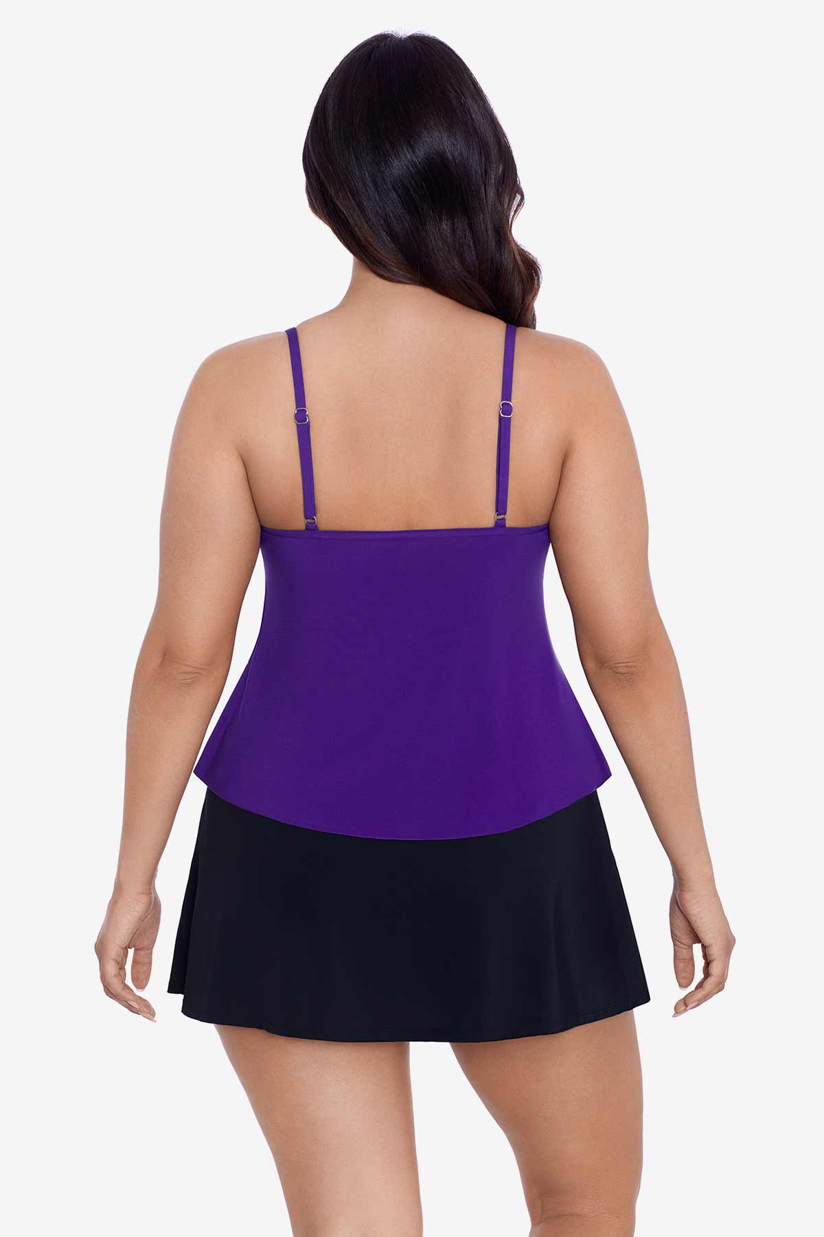Woman faced away wearing a purple tankini top with ruffles
