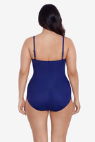 Woman turned away wearing a navy-blue one-piece swimsuit