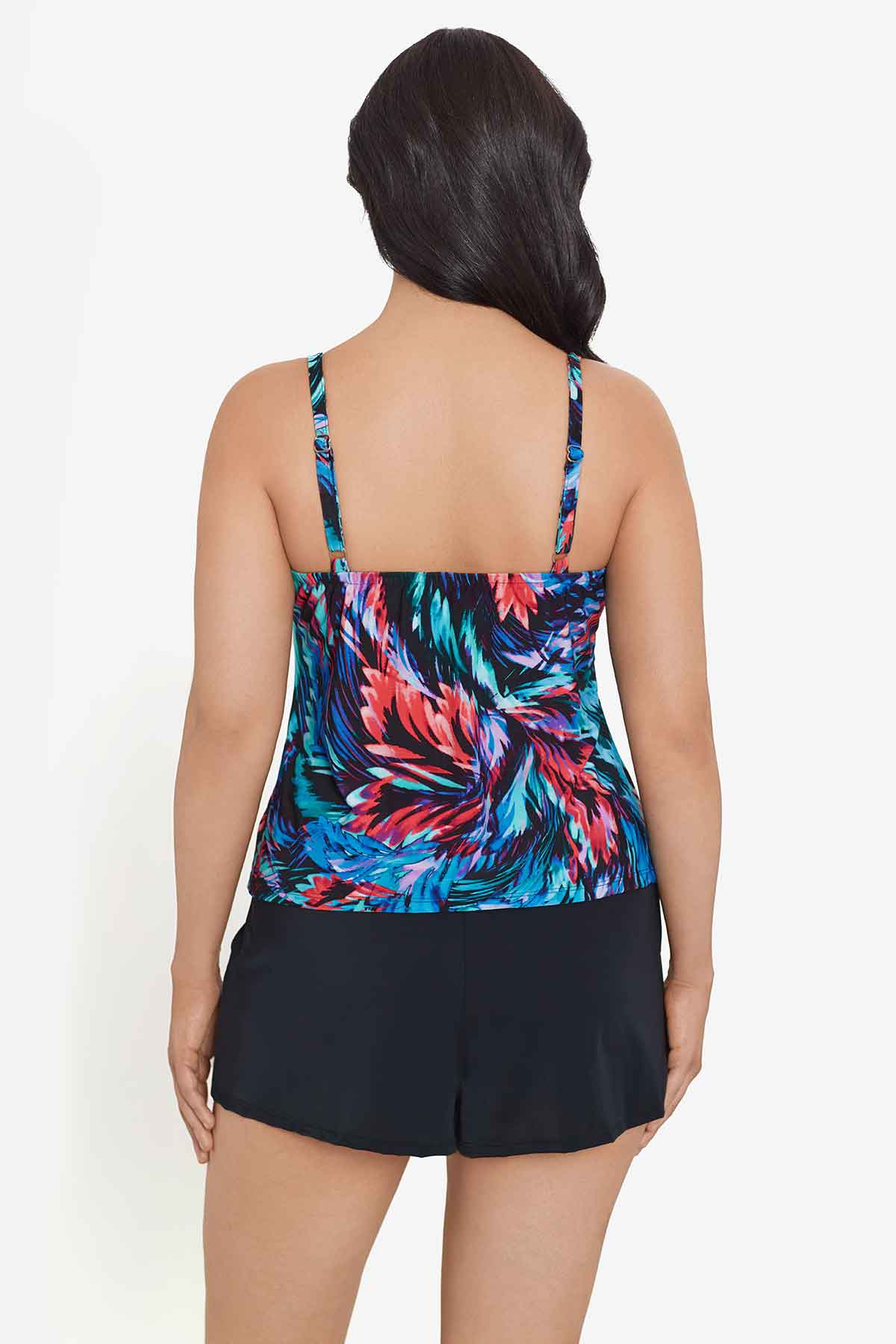 Woman faced away wearing a multicolored feather pattern swim romper