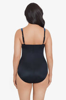 Woman turned away wearing a blue abstract printed one-piece swimsuit