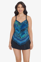 Woman wearing a blue and black palm leaf and tile printed tankini top