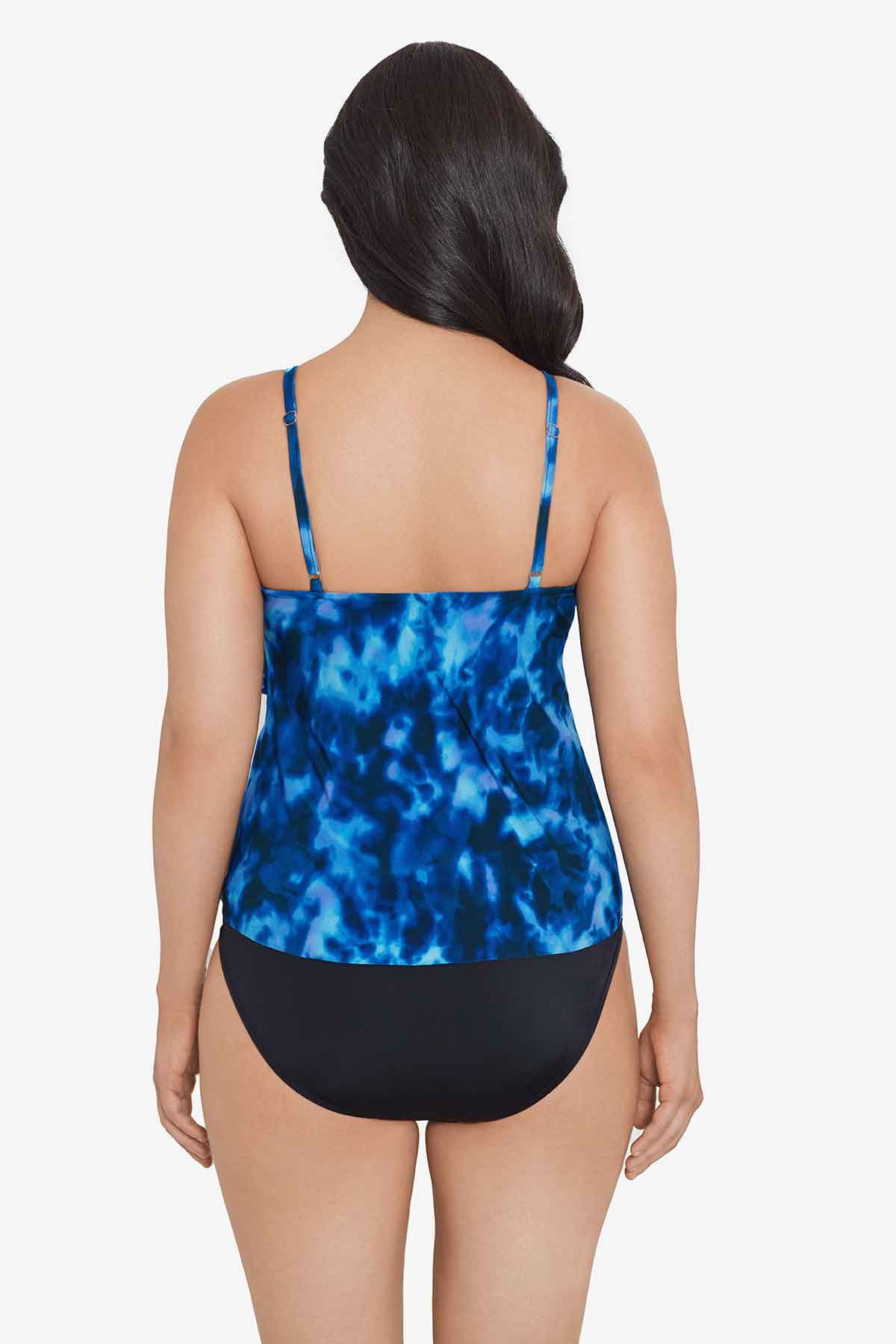 Woman faced away wearing a blue tie dye ruffle tankini top