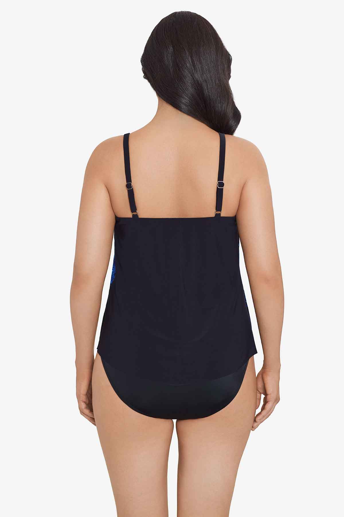 Woman faced away wearing a blue and purple tile printed tankini top