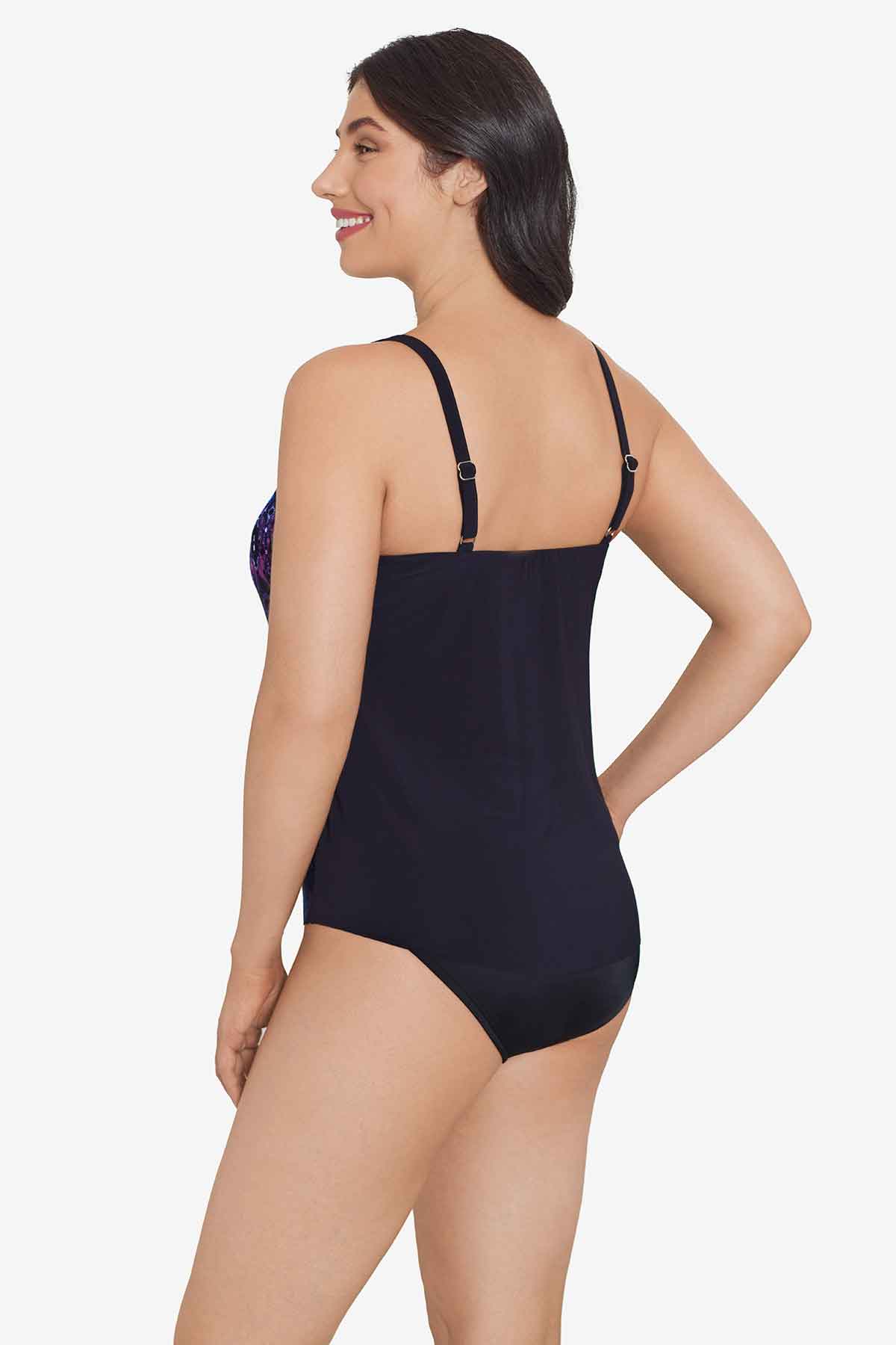 Woman turned left wearing a blue and purple tile printed tankini top