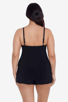 Woman faced away wearing a black swim romper