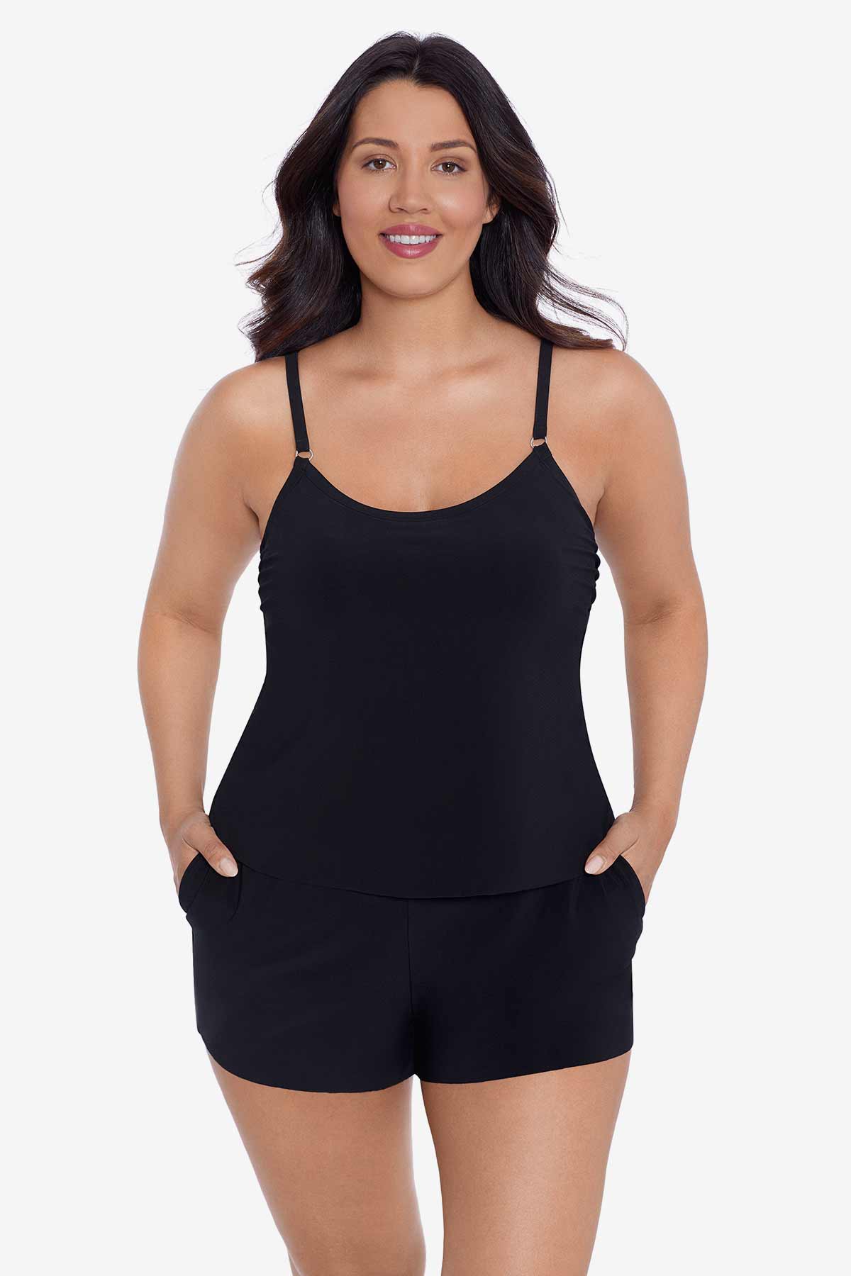Woman wearing a black swim romper with pockets