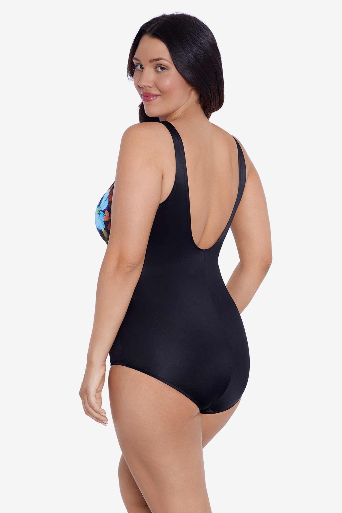 Woman faced left wearing a blue and maroon floral printed one-piece swimsuit
