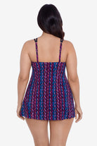 Woman turned away wearing a purple and blue stripey pattern swim dress