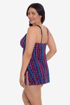 Woman turned left wearing a purple and blue stripey pattern swim dress
