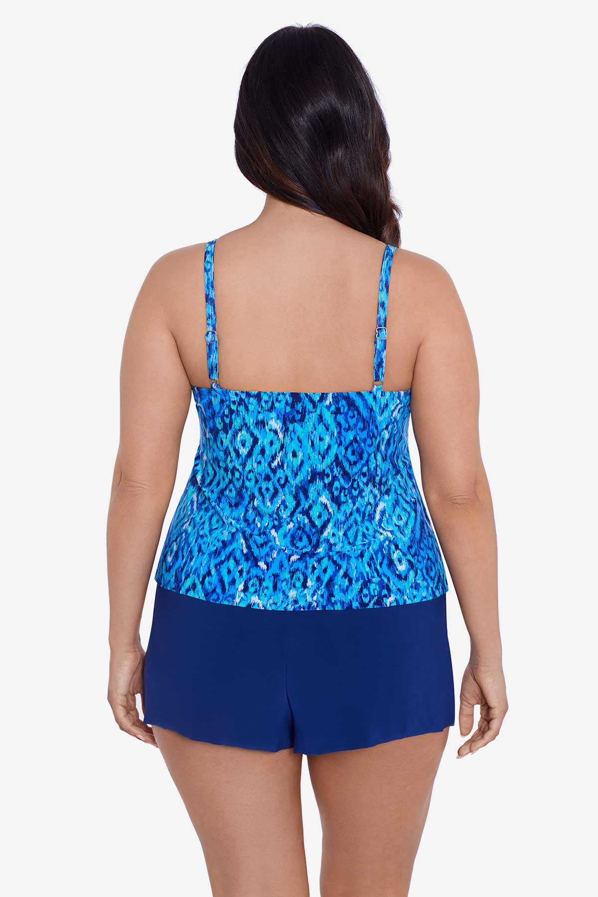 Woman turned away wearing a blue diamond printed swim romper