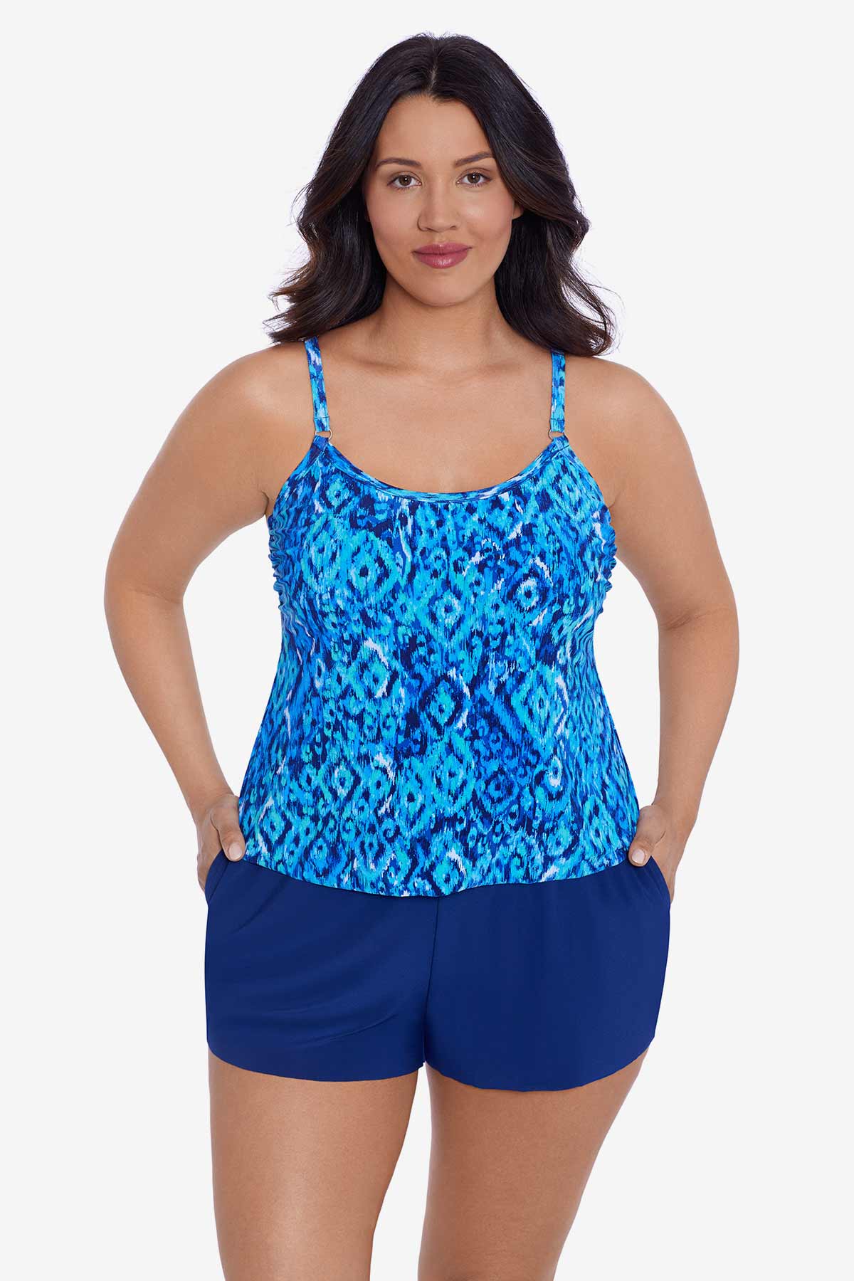 Woman wearing a blue diamond printed swim romper with pockets
