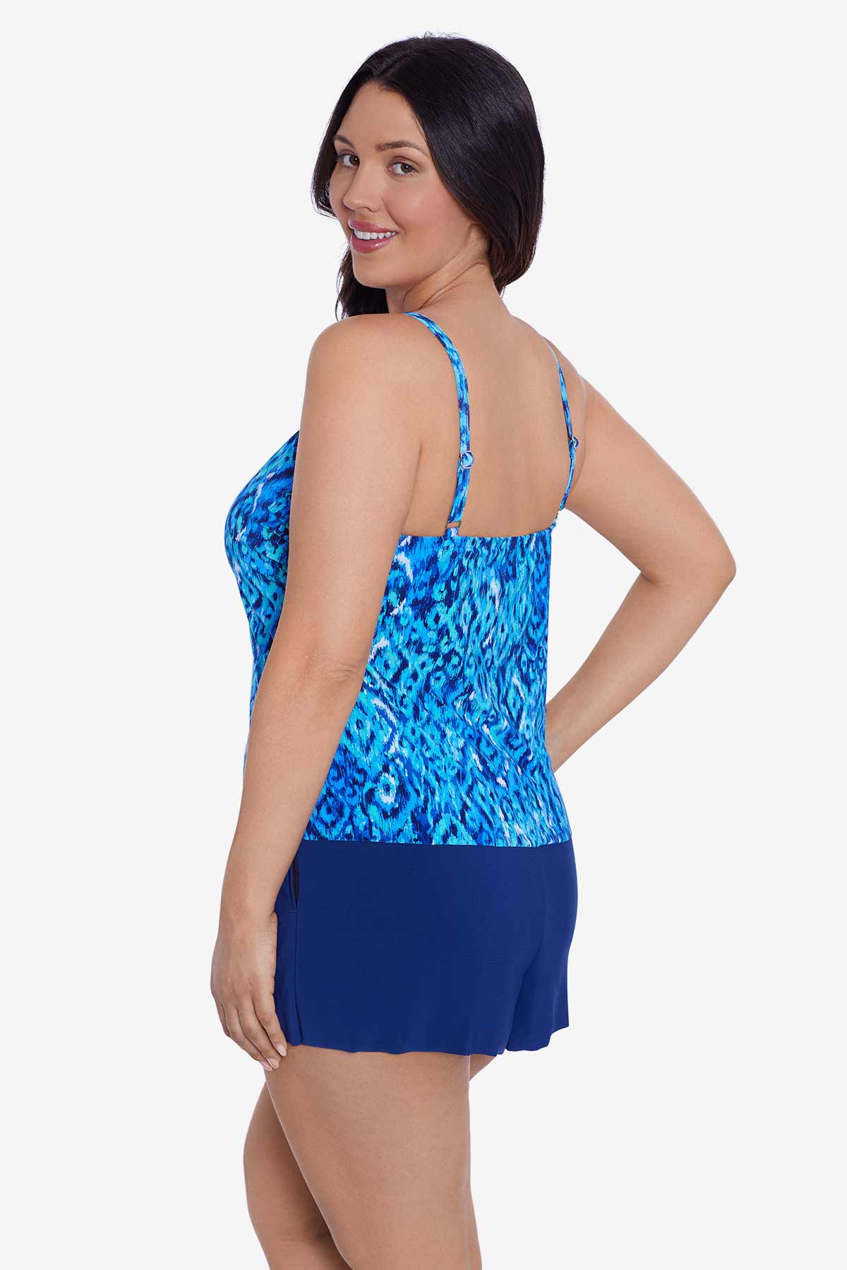 Woman turned left wearing a blue diamond printed swim romper