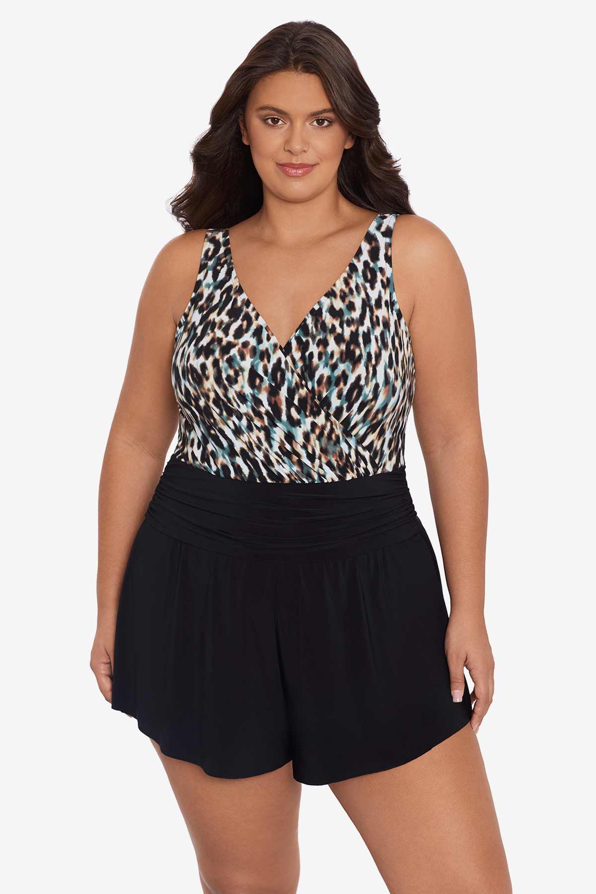 Woman wearing a leopard printed swim romper with black shorts