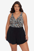 Woman wearing a leopard printed swim romper with black shorts