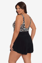 Woman faced left wearing a leopard printed swim romper with black shorts