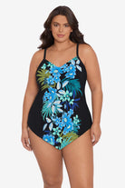 Woman wearing a black tankini top with a blue floral pattern down the front