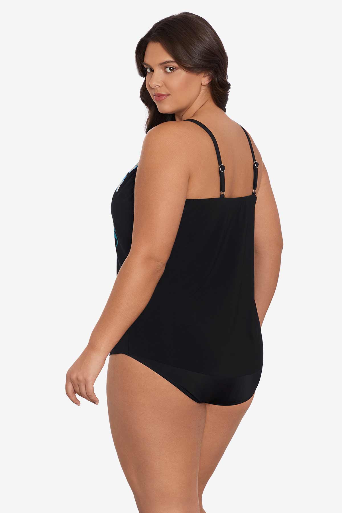 Woman turned left wearing a black tankini top with a blue floral pattern down the front