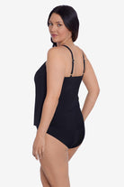 Woman turned left wearing a black tankini top with a blue floral pattern down the front