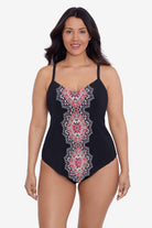 Woman wearing a black tankini top with a red and white tile pattern down the front