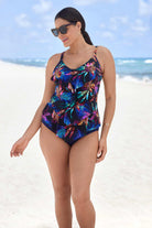 Woman on beach wearing a multicolored tropical pattern tiered tankini top