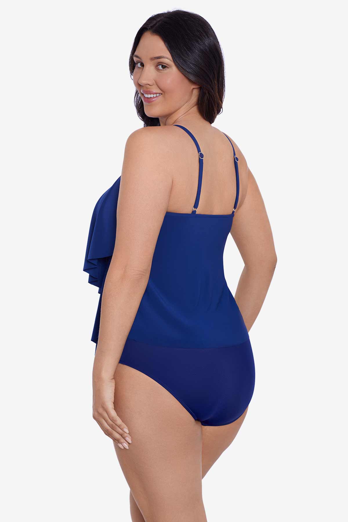 Woman faced left wearing a navy-blue tiered ruffle tankini top