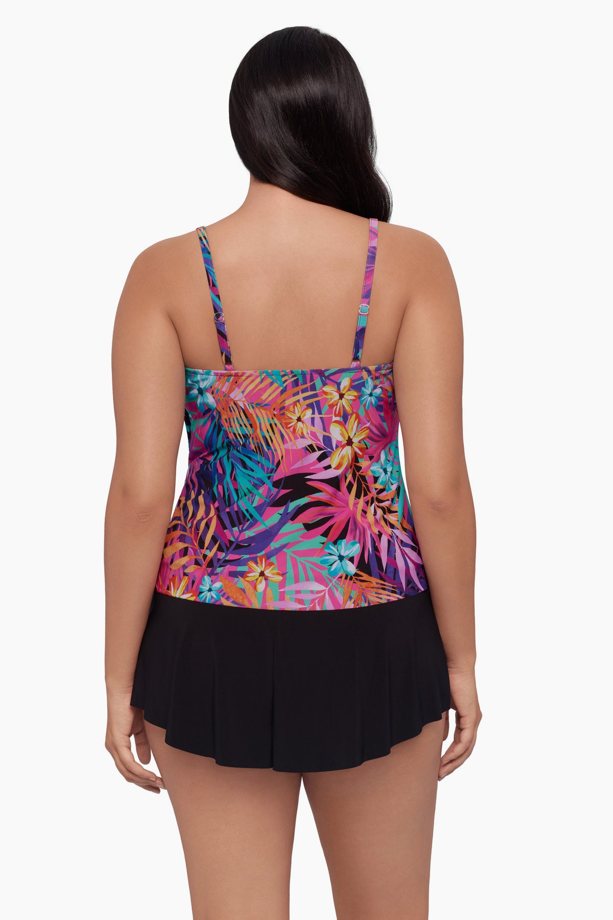 Woman turned away wearing a tankini top with a neon palm leaf print