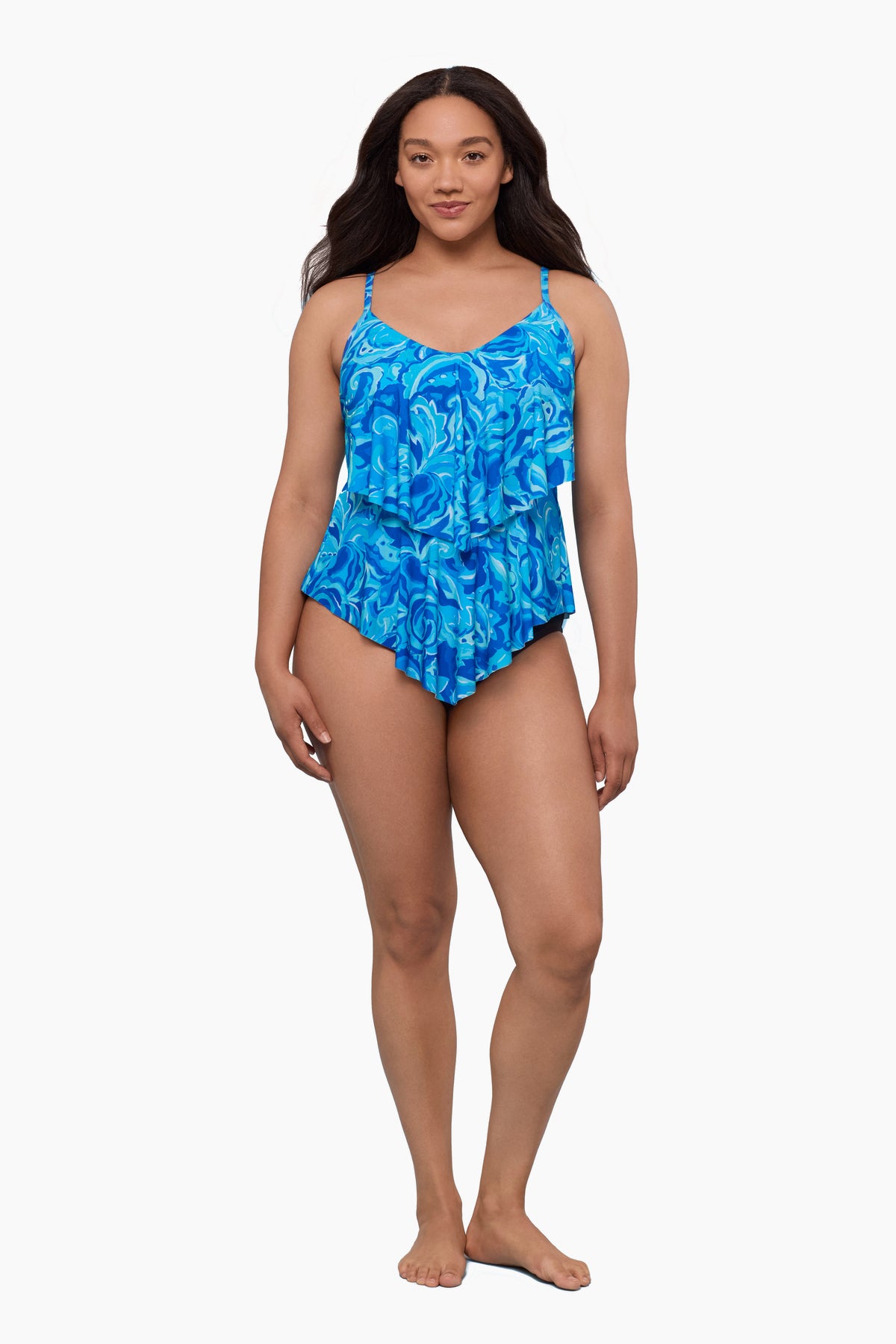 Woman wearing a tiered tankini top with an abstract blue pattern