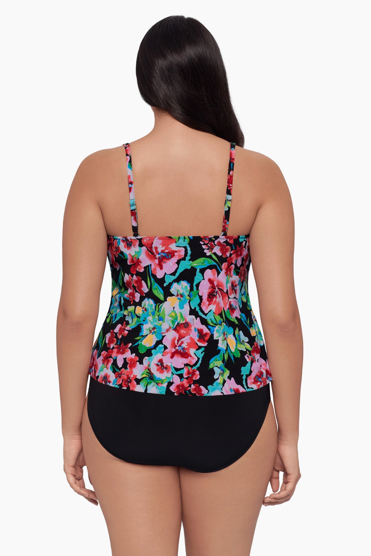 Woman turned away wearing a tankini top with a floral print