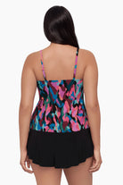 Woman turned away wearing a
tankini top with a collage patchwork print