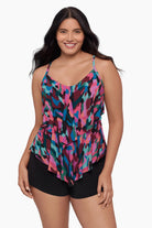 Woman wearing a tiered tankini top with a collage patchwork print