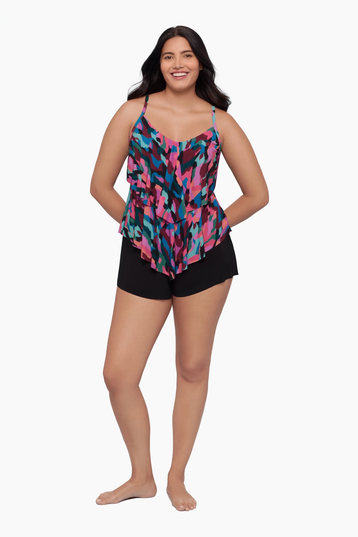 Woman wearing a tiered tankini top with a collage patchwork print