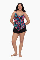 Woman wearing a tiered tankini top with a collage patchwork print