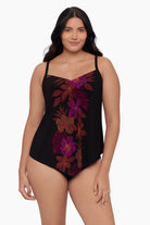 Woman wearing a tankini top with a faded floral print