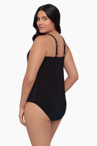 Woman turned left wearing a tankini top with a floral pattern 