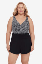 Woman wearing a black and white lace-esque pattern swim romper