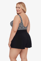 Woman faced left wearing a black and white lace-esque pattern swim romper