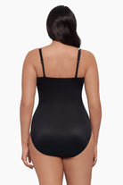 Woman faced away wearing a one-piece swimsuit