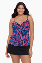 Woman wearing a tankini top with a pink and blue print