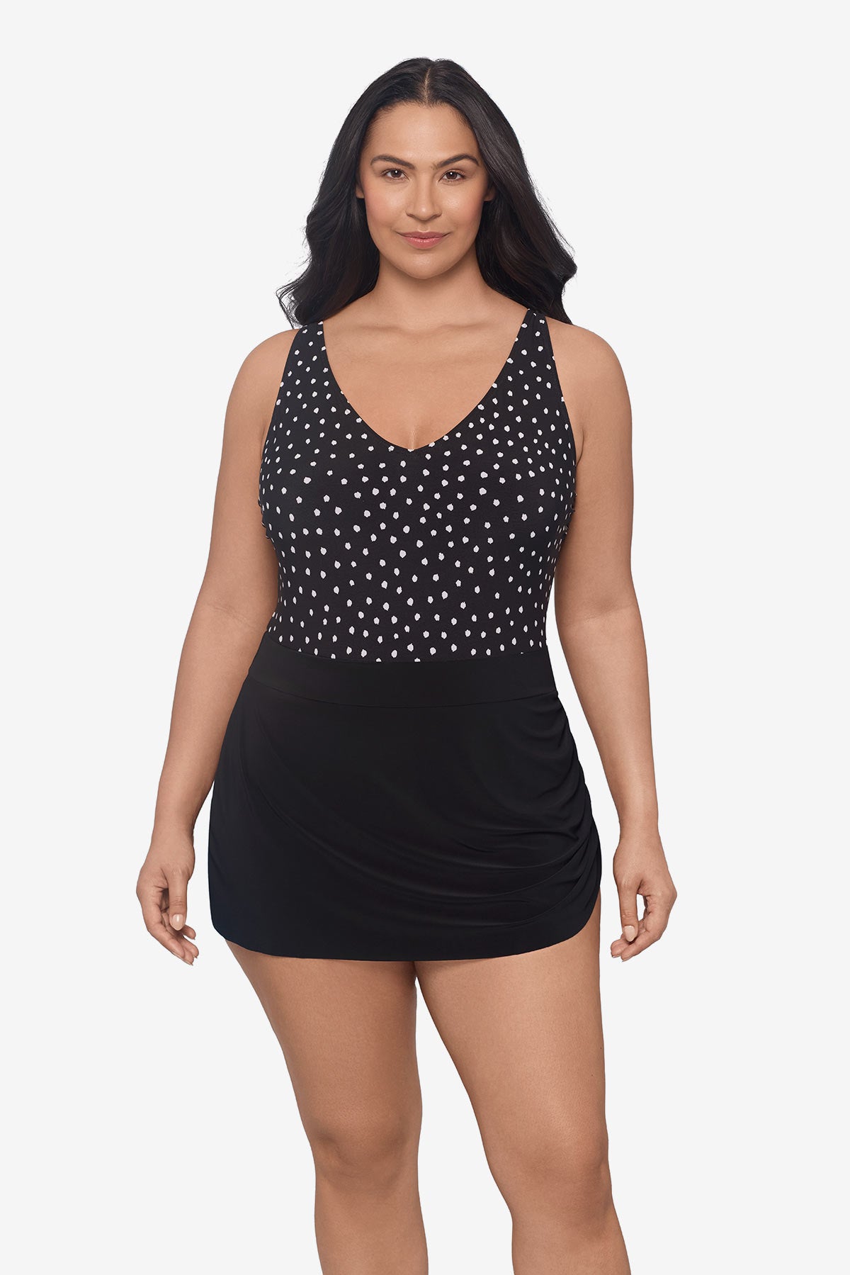 Woman wearing a black and white polka dot swim dress