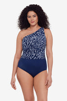 Woman wearing a blue and white abstract printed one-piece swimsuit
