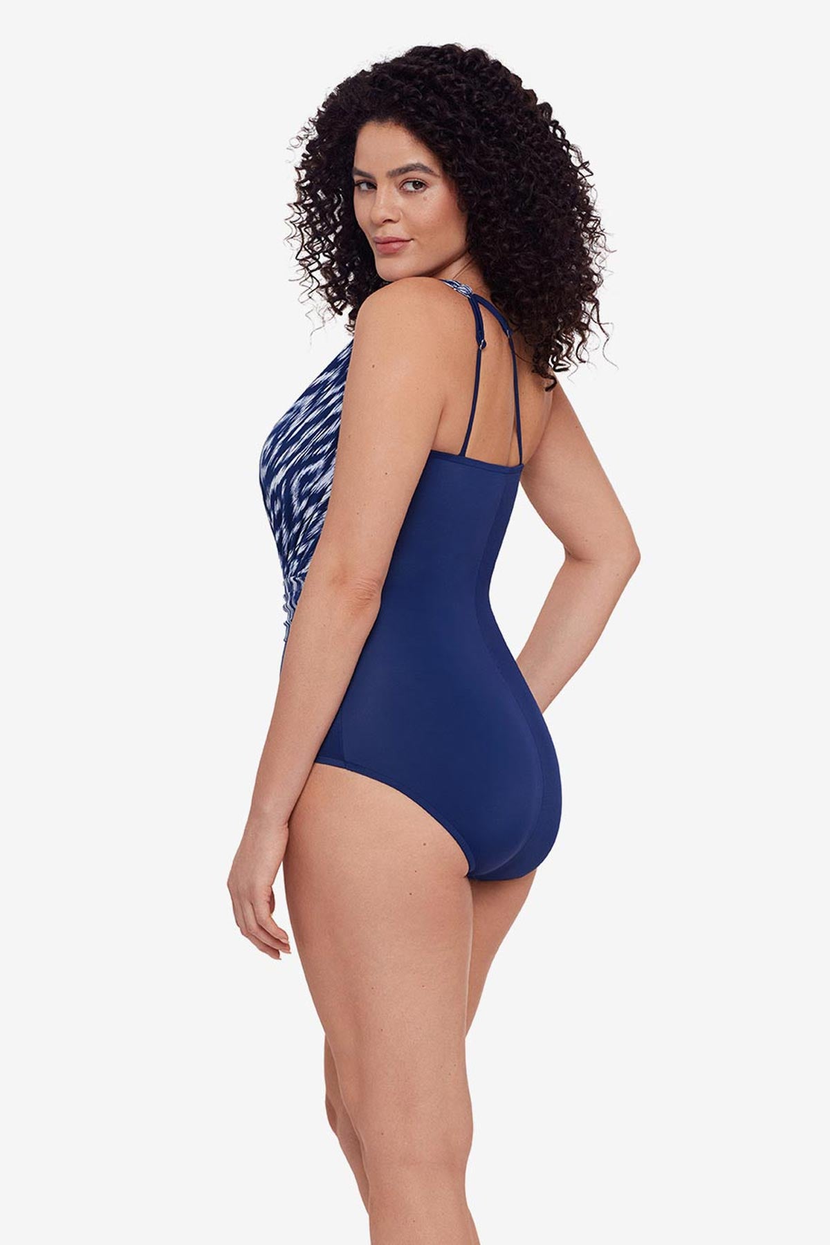 Woman turned left wearing a blue and white abstract printed one-piece swimsuit