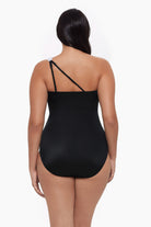 Woman turned away wearing a one-piece swimsuit with an asymmetrical cut